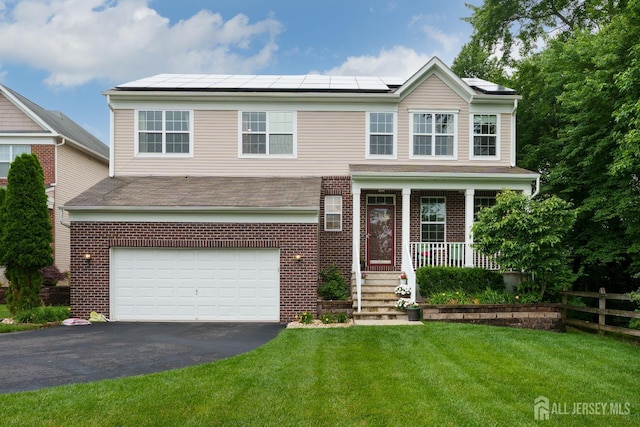 1 Elmcrest Ct E, Monroe, NJ 08831 - view of front facade featuring a garage, driveway, a porch, brick siding, and roof mounted solar panels