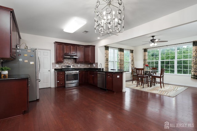 1 Elmcrest Ct E, Monroe, NJ 08831 - kitchen featuring stainless steel appliances, dark countertops, under cabinet range hood, and dark wood-style floors