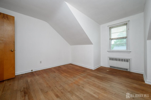 4 Ashwood Pl, North Brunswick, NJ 08902 - additional living space featuring radiator heating unit, hardwood / wood-style flooring, vaulted ceiling, and baseboards