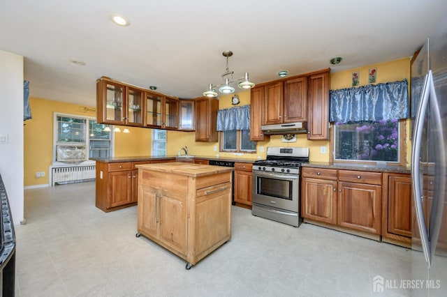4 Ashwood Pl, North Brunswick, NJ 08902 - kitchen with stainless steel appliances, radiator heating unit, under cabinet range hood, a sink, and a center island
