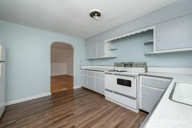 4 Ashwood Pl, North Brunswick, NJ 08902 - kitchen featuring white appliances, open shelves, arched walkways, light countertops, and dark wood-type flooring