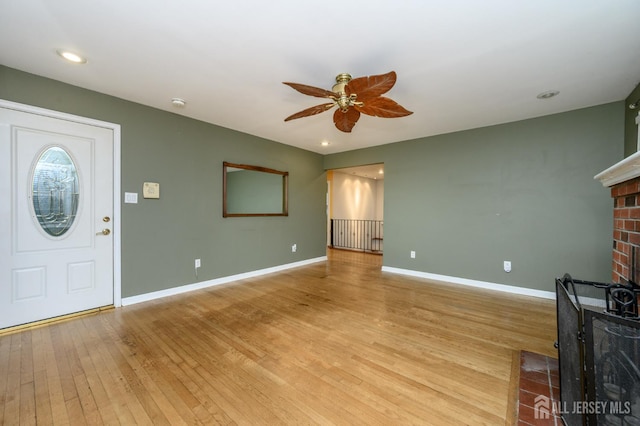 4 Ashwood Pl, North Brunswick, NJ 08902 - unfurnished living room with a brick fireplace, ceiling fan, light wood-type flooring, baseboards, and recessed lighting