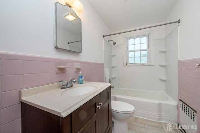 4 Ashwood Pl, North Brunswick, NJ 08902 - bathroom with tile walls, radiator heating unit, vanity, tub / shower combination, and toilet