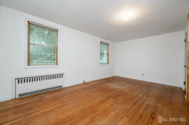 4 Ashwood Pl, North Brunswick, NJ 08902 - unfurnished room featuring radiator, wood finished floors, and baseboards