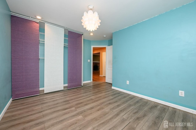 4 Ashwood Pl, North Brunswick, NJ 08902 - unfurnished bedroom featuring wood finished floors, baseboards, recessed lighting, and a chandelier