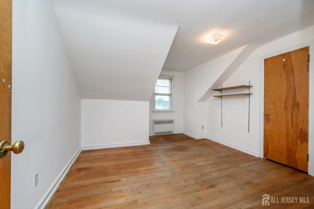 4 Ashwood Pl, North Brunswick, NJ 08902 - bonus room with radiator heating unit, vaulted ceiling, wood finished floors, and baseboards
