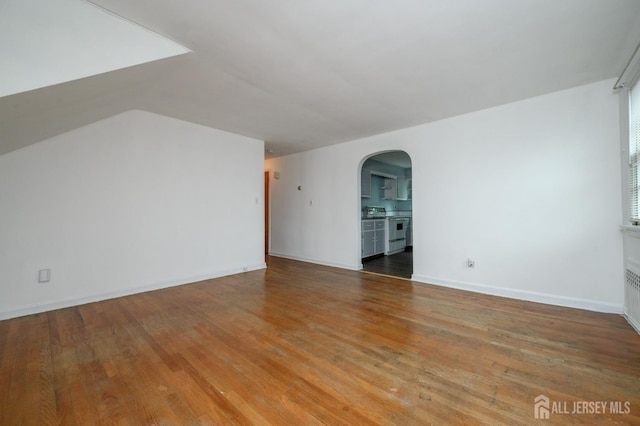 4 Ashwood Pl, North Brunswick, NJ 08902 - additional living space featuring arched walkways, wood finished floors, baseboards, and vaulted ceiling