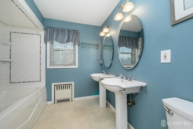 4 Ashwood Pl, North Brunswick, NJ 08902 - bathroom featuring radiator heating unit, toilet, baseboards, and tile patterned flooring
