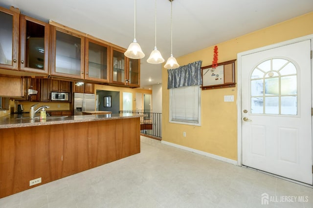 4 Ashwood Pl, North Brunswick, NJ 08902 - kitchen featuring appliances with stainless steel finishes, a peninsula, brown cabinets, and glass insert cabinets