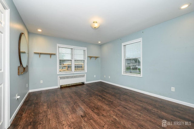 4 Ashwood Pl, North Brunswick, NJ 08902 - unfurnished living room with radiator heating unit, baseboards, wood finished floors, and recessed lighting