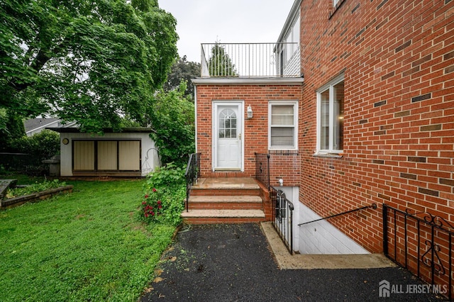 4 Ashwood Pl, North Brunswick, NJ 08902 - doorway to property featuring brick siding and a yard