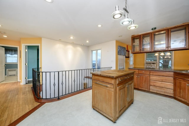 4 Ashwood Pl, North Brunswick, NJ 08902 - kitchen featuring radiator heating unit, butcher block counters, recessed lighting, glass insert cabinets, and plenty of natural light