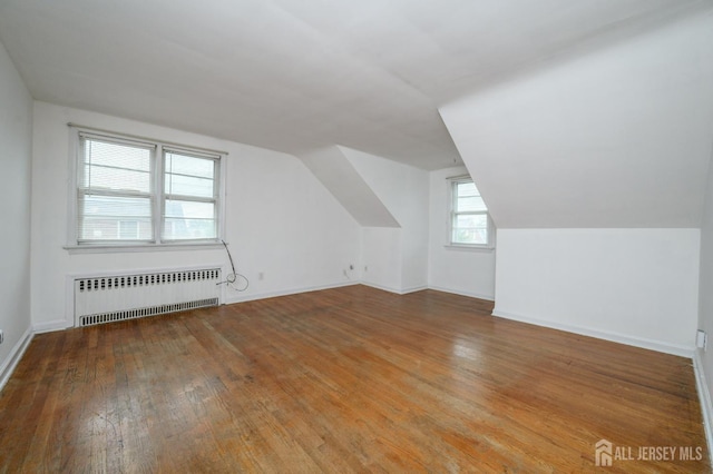 4 Ashwood Pl, North Brunswick, NJ 08902 - bonus room featuring radiator heating unit, wood finished floors, lofted ceiling, and baseboards