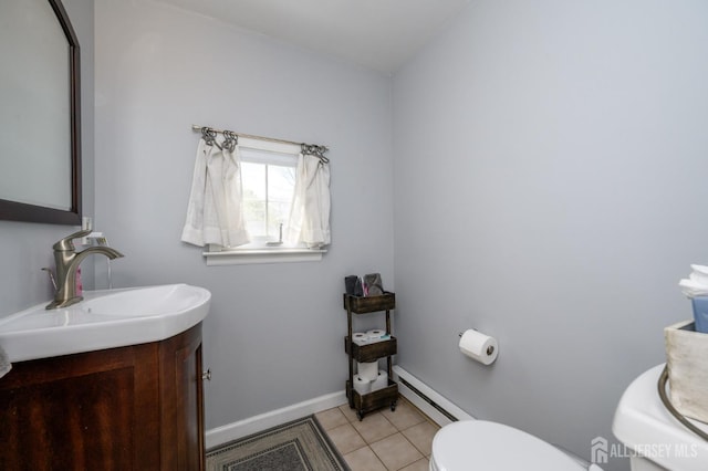 47 Lincoln Ave, Jamesburg, NJ 08831 - half bath featuring baseboards, toilet, baseboard heating, vanity, and tile patterned floors