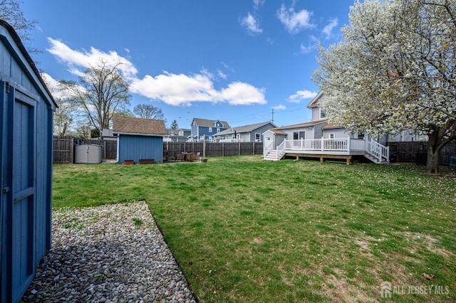 47 Lincoln Ave, Jamesburg, NJ 08831 - view of yard featuring an outbuilding, a fenced backyard, a deck, and a shed