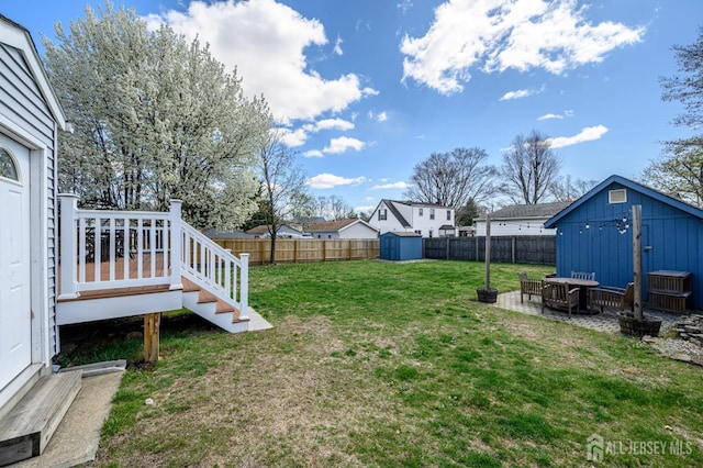 47 Lincoln Ave, Jamesburg, NJ 08831 - view of yard with a storage shed, a fenced backyard, a wooden deck, and an outdoor structure