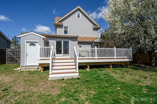 47 Lincoln Ave, Jamesburg, NJ 08831 - rear view of house with a fenced backyard, a wooden deck, and a lawn