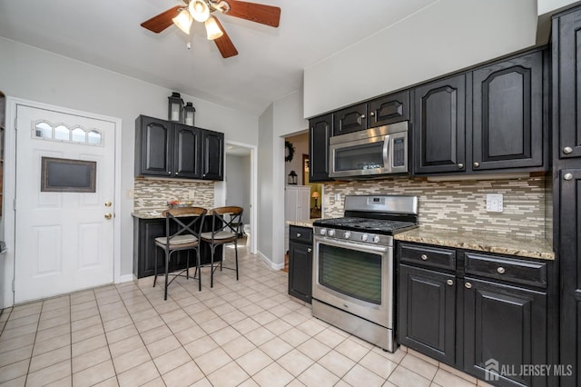 47 Lincoln Ave, Jamesburg, NJ 08831 - kitchen with tasteful backsplash, a ceiling fan, dark cabinetry, light stone countertops, and stainless steel appliances