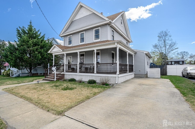 47 Lincoln Ave, Jamesburg, NJ 08831 - view of front of house featuring roof with shingles, driveway, a front yard, a porch, and fence