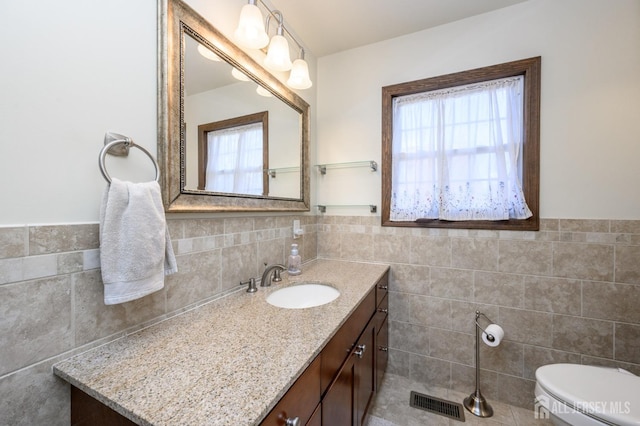 47 Lincoln Ave, Jamesburg, NJ 08831 - bathroom with tile walls, plenty of natural light, visible vents, and toilet