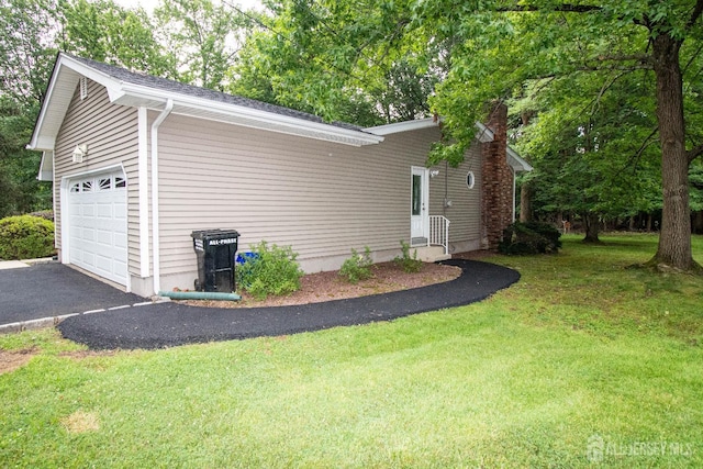 33 Timber Rd, Edison, NJ 08820 - view of home's exterior featuring an attached garage, driveway, and a yard