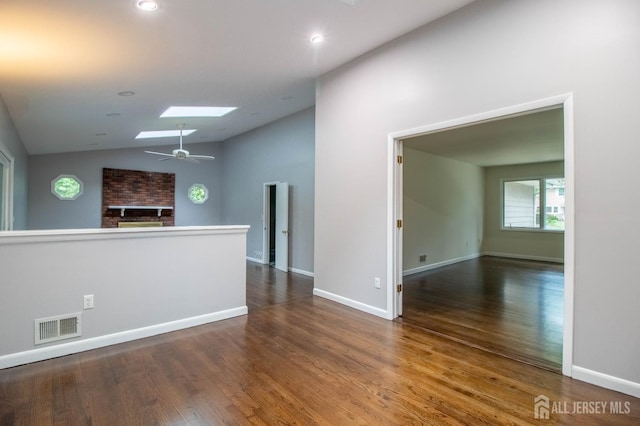 33 Timber Rd, Edison, NJ 08820 - empty room featuring a skylight, vaulted ceiling, wood finished floors, a brick fireplace, and recessed lighting