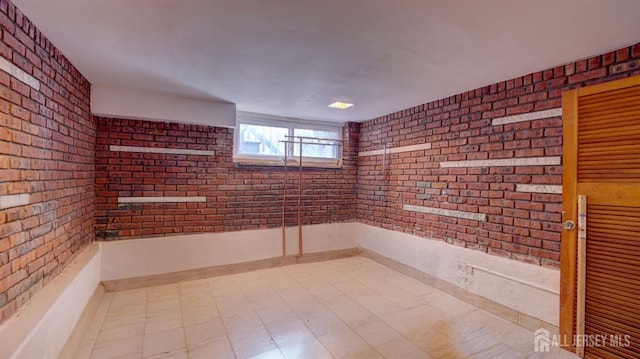 interior space featuring brick wall