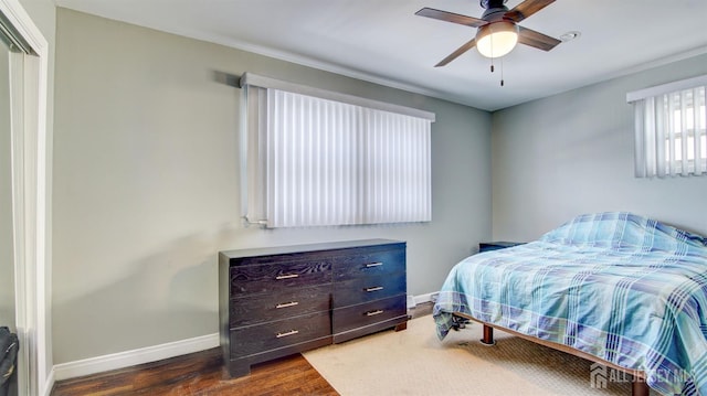 bedroom with baseboards, wood finished floors, and a ceiling fan