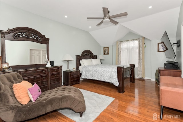 bedroom with wood finished floors, recessed lighting, lofted ceiling, a ceiling fan, and baseboards