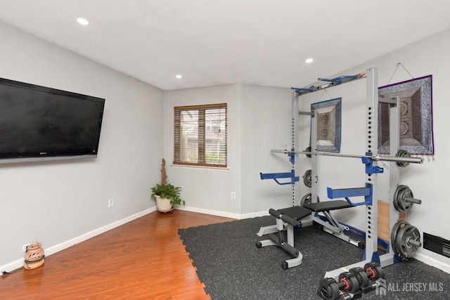 exercise room featuring recessed lighting, baseboards, and wood finished floors