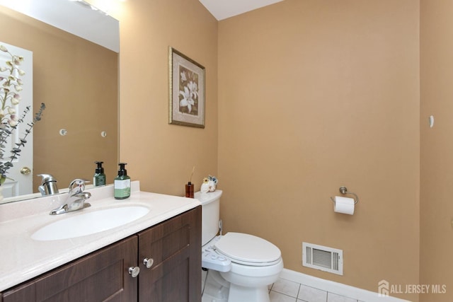 bathroom featuring tile patterned floors, toilet, and vanity