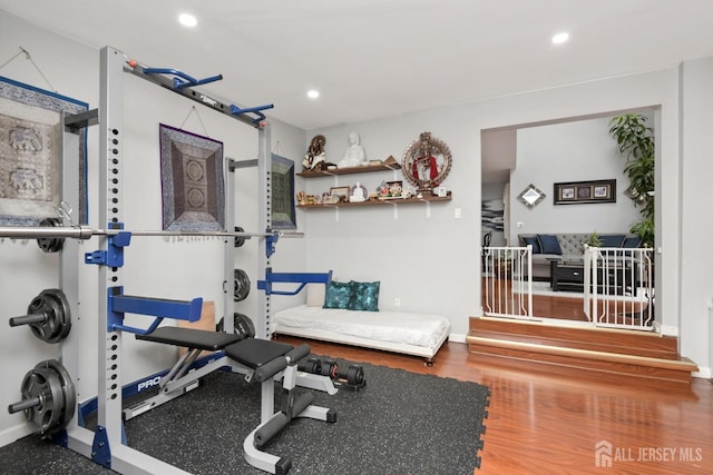 exercise room with recessed lighting, baseboards, and wood finished floors