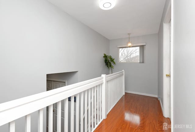 hallway with wood finished floors and baseboards
