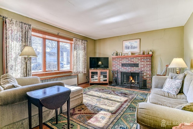 living room with wood finished floors, radiator, and a fireplace