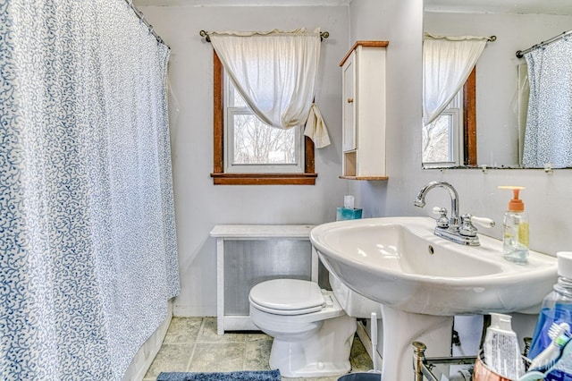 bathroom with a shower with curtain, tile patterned floors, and toilet