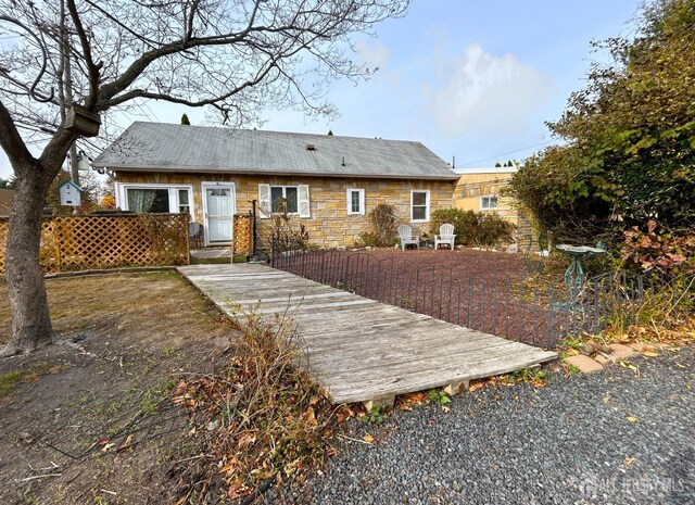 rear view of property with a wooden deck