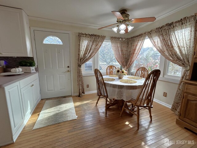 dining room with ceiling fan and light wood-type flooring