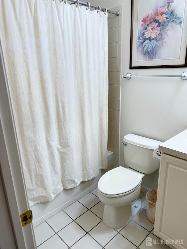 full bath featuring tile patterned floors, shower / bath combination with curtain, vanity, and toilet