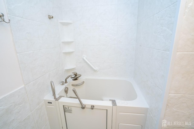 bathroom featuring a sink and tile walls