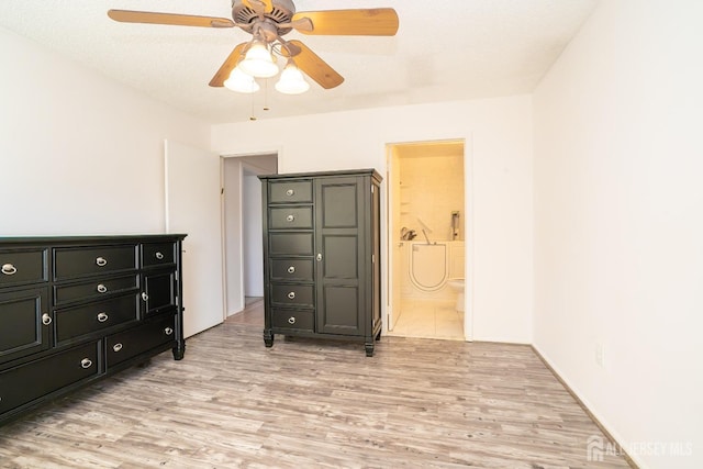 bedroom with ceiling fan, a textured ceiling, connected bathroom, and light wood-style floors