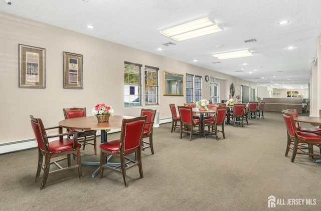 dining area with recessed lighting, light colored carpet, visible vents, baseboard heating, and a textured ceiling