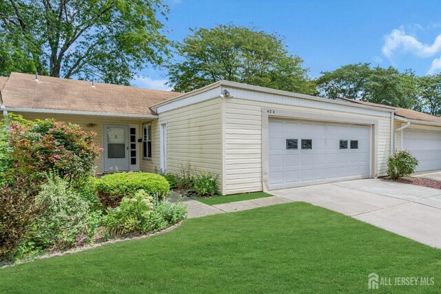 exterior space featuring a garage and a front lawn