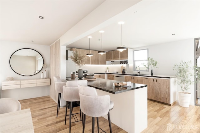 kitchen with a breakfast bar, light wood-style flooring, stainless steel dishwasher, modern cabinets, and a sink