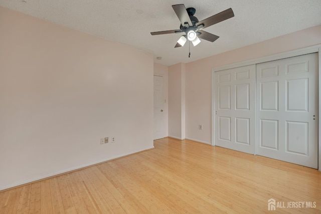 26 Desoto Dr, Franklin Twsp, NJ 08823 - unfurnished bedroom with light wood-style flooring, a closet, and a ceiling fan
