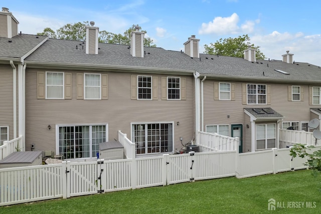 26 Desoto Dr, Franklin Twsp, NJ 08823 - rear view of property with a gate, a fenced backyard, and a chimney