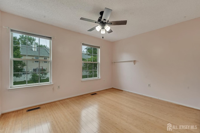 26 Desoto Dr, Franklin Twsp, NJ 08823 - unfurnished room featuring a ceiling fan, hardwood / wood-style flooring, and a textured ceiling