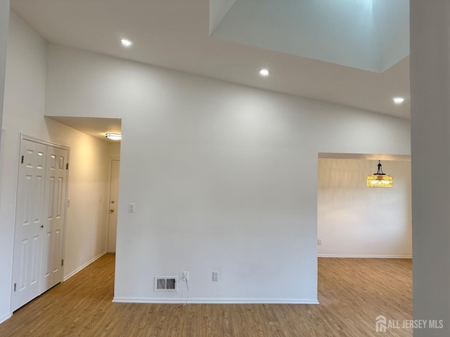 empty room featuring visible vents, recessed lighting, wood finished floors, and baseboards