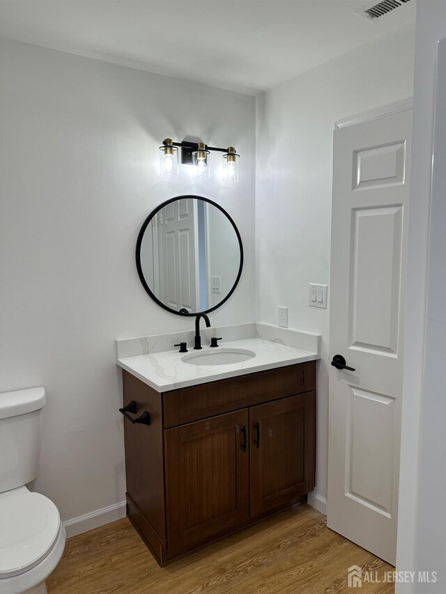 299 Alpine Way Unit C, Woodbridge Proper, NJ 07095 - bathroom featuring wood finished floors, toilet, vanity, and baseboards
