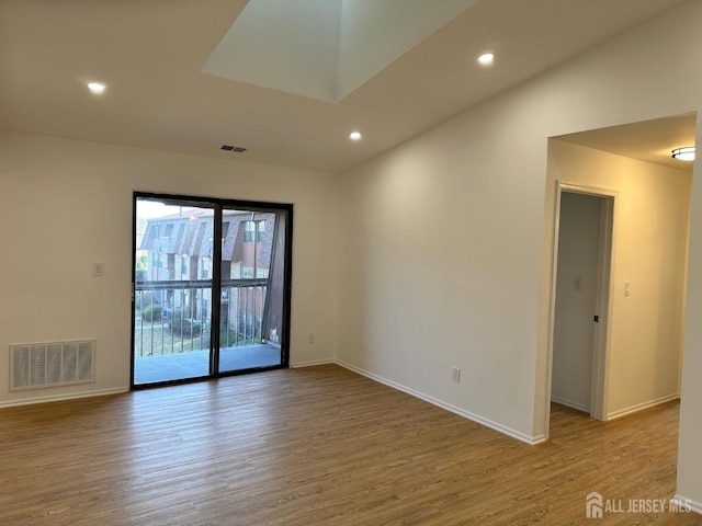 empty room with visible vents, recessed lighting, baseboards, and wood finished floors