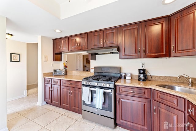 135 Archery Ct, Old Bridge, NJ 08857 - kitchen with light tile patterned flooring, light stone counters, a sink, gas stove, and under cabinet range hood